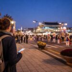Andong Maskdance Festival 2026 opening-night route with a visitor watching a mask-dance parade near Andong Station