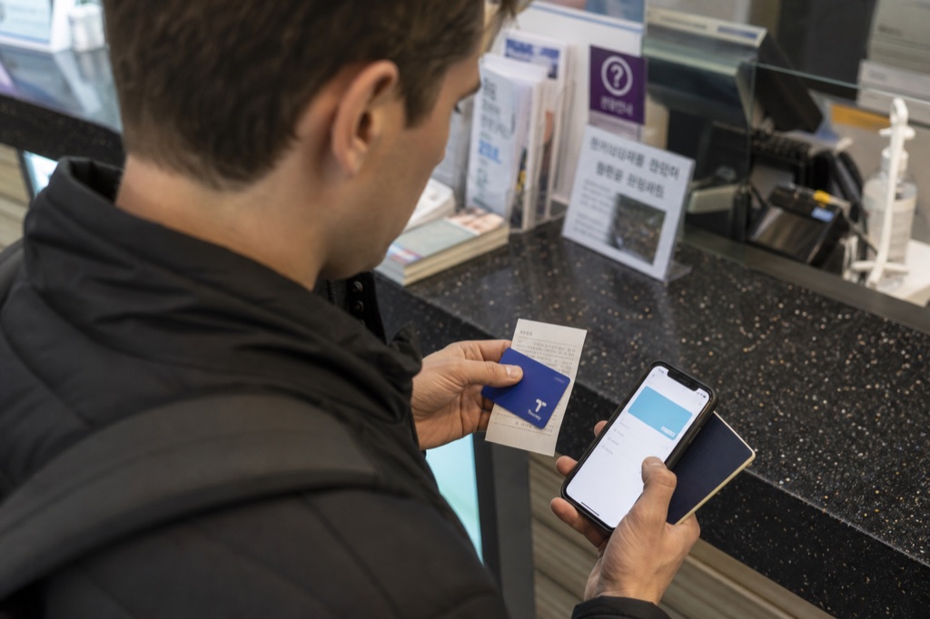 T-money refund Korea without Korean bank account 2026 traveler checking a transit card and receipt