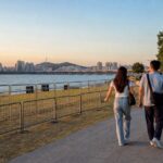 Nodulseom Orange Play Zone tickets and entry 2026 Han River viewing area at dusk with visitors approaching the riverside venue